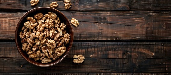 Canvas Print - Top view of a bowl filled with walnuts on a wooden surface creating a rustic setting perfect for adding text with copy space image