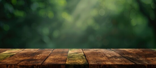 Sticker - Wooden table with no items on top placed against a blurred green background providing ample copy space image