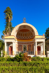 Wall Mural - Path with vibrant green trees in city park, Villa Giulia. Palermo, Sicily, Italy