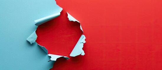 Poster - A hole in light blue paper with a red background serves as a striking copy space image