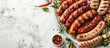 © Gular - Summer party food menu featuring various BBQ grilled sausages with herbs and spices on a marble tabletop Top view of the dish with copy space image