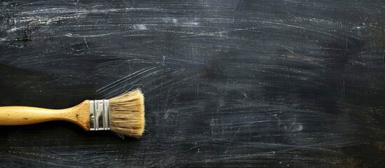 Poster - A blackboard with a brush erasing content against a black background suitable for adding text or graphics with copy space image