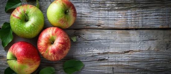 Wall Mural - Copy space image with green and red apples on a grainy grey wooden background for text and templates