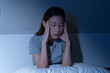 © KMPZZZ - Depressed anxiety asian young woman, girl frustrated closed eyes, touching face, suffering stressed, sick, tired, crisis sitting on bed from headache, migraine pain tension problem health care concept