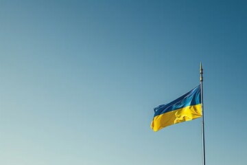 August 24th.Ukraine Independence Day.Flag of Ukraine.A serene scene of a Ukrainian flag gently waving in the wind against a clear blue sky, with a subtle, blurred background