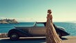 © David Martínez - Una mujer con un vestido elegante de época se encuentra junto a un coche clásico descapotable en una pintoresca carretera costera. El fondo presenta un mar azul profundo y una isla rocosa bajo un ciel