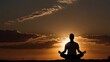 © Wulan - A person meditating in nature with the sunset casting a golden light
