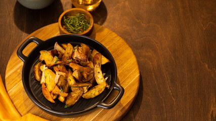 Vegetarian dish fried potatoes with garlic, parsley and chanterelle mushrooms closeup on a plate on the table. horizontal