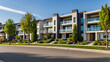 © janzwolinski - A row of modern suburban homes in a clean and well-maintained neighborhood on a sunny day with clear skies.