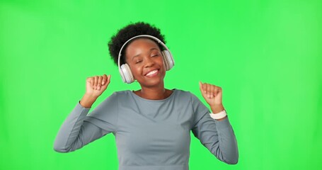 Poster - Dance, music and black woman with headphones on green screen for listening in studio isolated on a background. Radio, streaming and happy person with energy for moving, sound or audio on mockup space