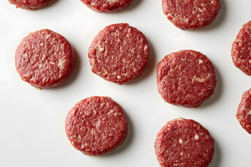 Uncooked beef burgers patty background isolated on a white background