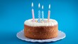 © Lee - fresh baked birthday cake with four candles blue back ground