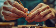 © SnowElf - A master jeweler setting gems into diamond ring, workshop with professional tools