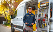 © tynza - A plumber standing next to a fully equipped work van, showcasing the organization and readiness of their tools and equipment.