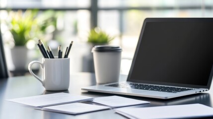 Canvas Print - Modern Workspace with Laptop, Papers, and Pencils - A sleek laptop rests on a modern desk, accompanied by a cup of coffee, papers, and a mug filled with pencils. The image symbolizes productivity, cre