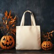 © Alena - Natural material tote bag mock up with autumn pumpkins. Beige canvas tote, blank template. Shopping bag mockup Your design here. Halloween tote bag mockup