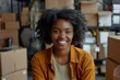 © Vorda Berge - Happy young black female Handling shipping and logistics in startup company office