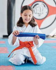 Canvas Print - Martial arts, belt and girl in studio for fitness, training and fight with discipline, development and respect. Student, kung fu and practice in dojo as workout for self defense, karate and taekwondo