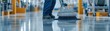 © Chanoknan - A worker uses a floor scrubber to clean a commercial space, ensuring a spotless and well-maintained environment.