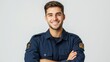 © Pavel Kachanau - A young man in uniform smiles confidently with arms crossed indoors