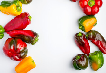 Multi-colored bell pepper on a white background. Top view, horizontal, copy space.