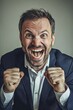 © grey - A excited businessman holding fists up celebrating with a big smile