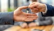© Thanaseth - Banker handing over keys for a mortgage loan agreement, closeup, happy client, modern office background