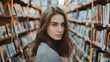 © liliyabatyrova - A woman stands in a library with many books around her