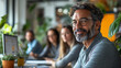 © feeling lucky - A confident man with glasses smiles at the camera while working in a modern office surrounded by colleagues and greenery.