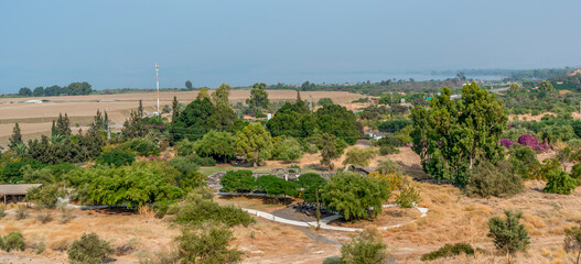 Panoramic view of the ruins at Kursi (Gerassa) National Park with the surrounding countryside and the Sea of Galilee behind it in Israel.
