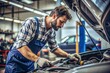 © Евгений Порохин - A man is working on a car engine in a garage