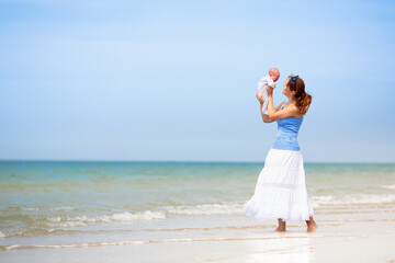 Wall Mural - Mother and child on beach. Vacation with baby.