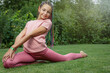 © frank11 - Flexible smiling  young girl is  performing gymnastic exercises in the garden. Horizontally.