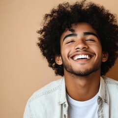 Wall Mural - Happy joyful young African American hipster guy isolated on beige background. Smiling funny ethnic teen student, cool curly gen z fashion model laughing with dental smile white teeth, portrait.