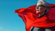 © Hope - Portrait of successful woman looking,  she nice attractive strong powerful cheerful cheery glad gray-haired lady wearing red costume super granny on blue wall with copy space