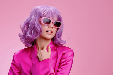 Wall Mural - Purplehaired woman wearing sunglasses and a pink robe, standing against a pink background, exuding a vibrant and stylish vibe