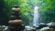 Stone pyramid near a tropical waterfall. The concept of harmony and balance.