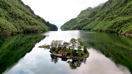 Wall Mural - Breathtaking aerial view ofLovrafjorden, Norway, showcasing serene waters and lush greenery. Perfect for travel and nature enthusiasts, red cabin on an Island in the middle of a fjord