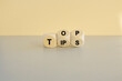 © Liudmila - Top tips symbol. Turned wooden cubes with words 'Top tips'. Beautiful grey table, beige background. Top tips and business concept.