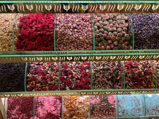 Racks of different types of dried flowers to use as tea