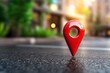 © Punprapa - A red pin marker on the ground, like an icon for maps. symbolizing location information or branding within online search engine applications.