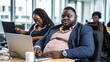 © елена калиничева - Dark skinned plus-size, overweight beautiful large male businessman using laptop at desk in modern office