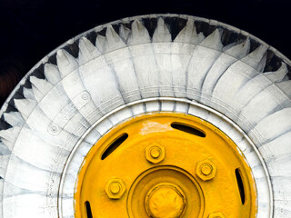 A detailed view of tire a blue bus with yellow and white sunflower