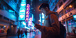 © theevening - A male using smartphone standing on the night city street full of neon light.