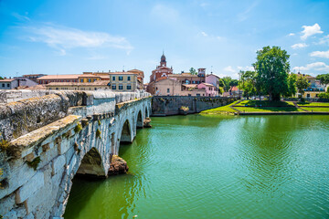 Wall Mural - A view south along the west side of the Roman Tiberius Bridge at Rimini, Italy in summertime