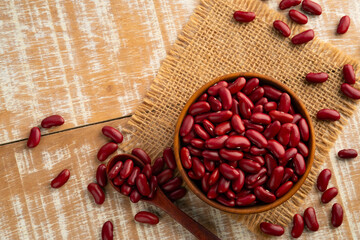 Uncooked Kidney bean or Red beans in wooden teak bowl with copy space.Top view.