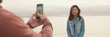 © Andrii Nekrasov - Man takes photo of woman on the shore, panorama