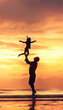 © sennauli - Father Tossing Daughter in the Air at Sunset on a Beach