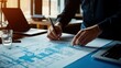 © waliyah - Architect Working on a Blueprint