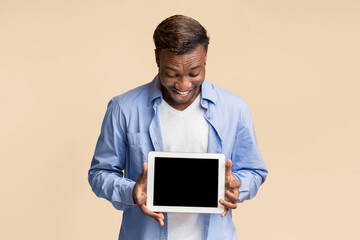 Wall Mural - Mobile App. Afro Man Holding Digital Tablet With Blank Screen Standing Over Yellow Studio Background. Mockup